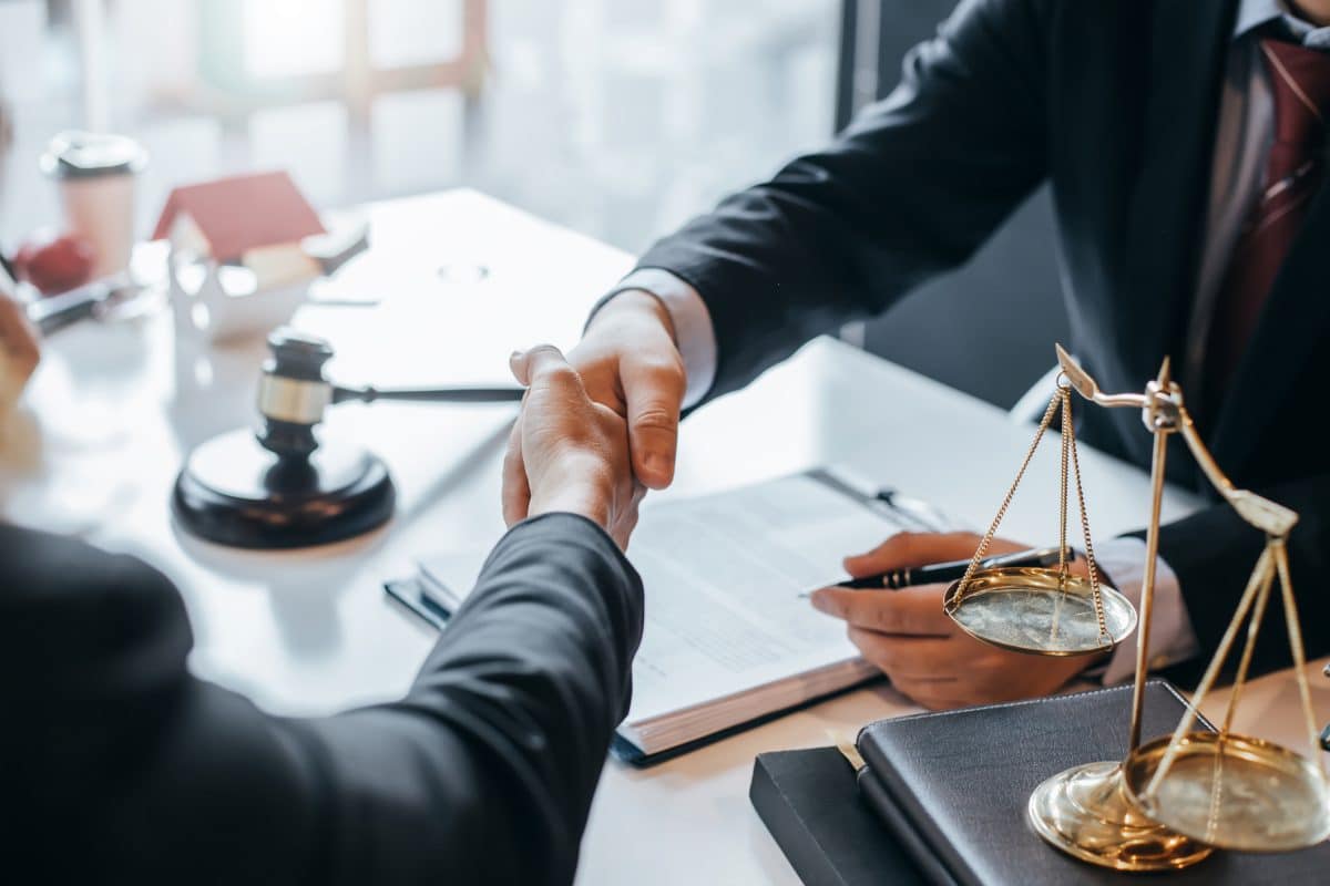  A medical malpractice lawyer shakes the hand of a client after winning a case in Alabama. 