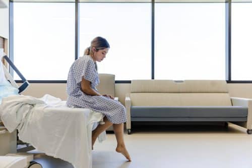 A patient sits alone uncared for in a hospital in Alabama.