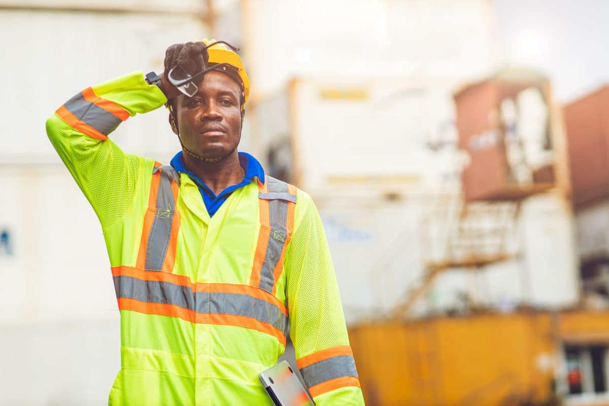 A worker looking tired and stressed on the job.