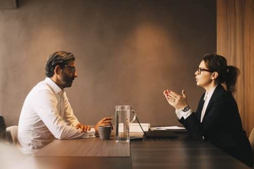 A man discussing a lawsuit with his car accident attorney.