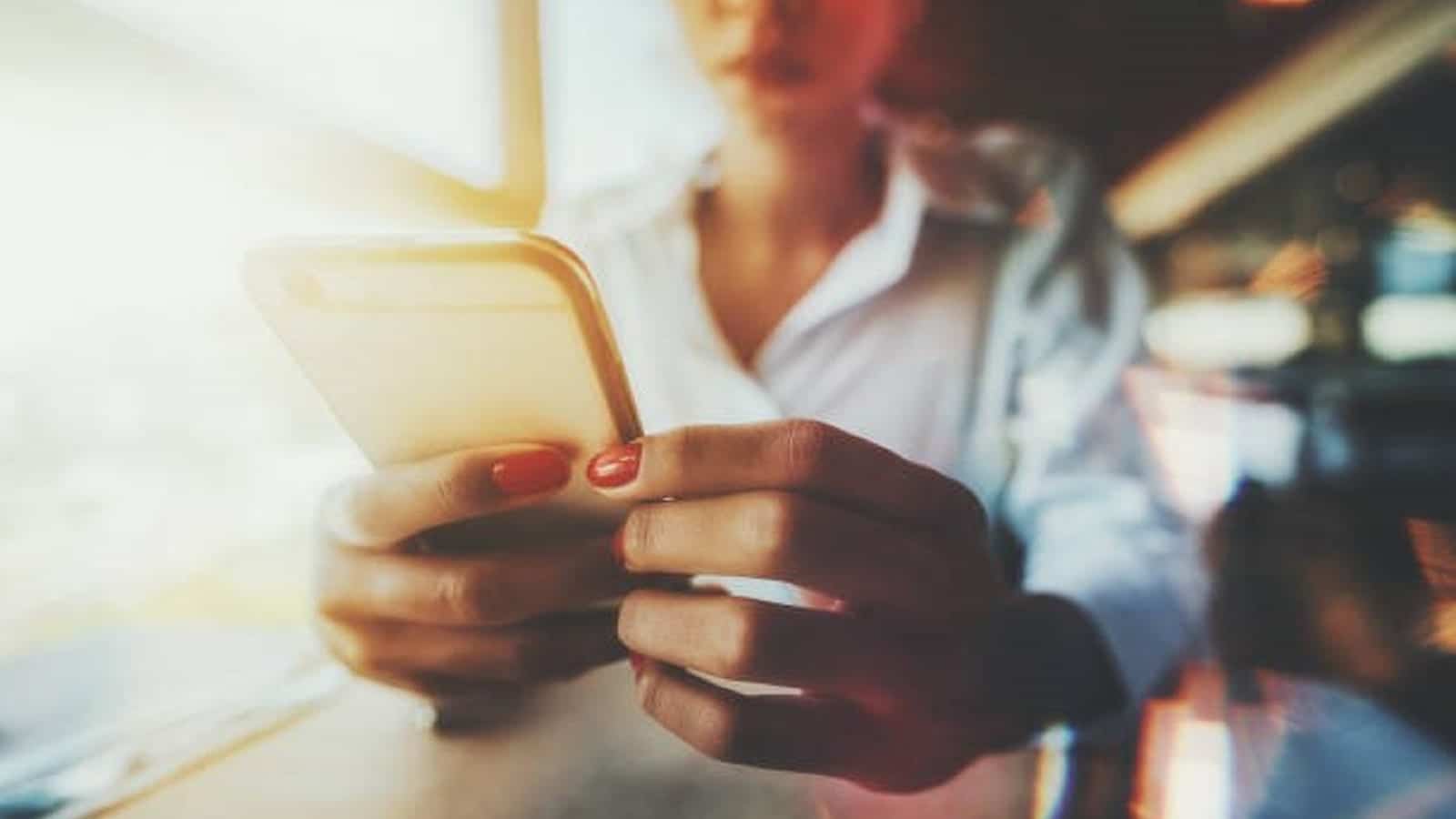 Young Woman Dialing On Her Smartphone