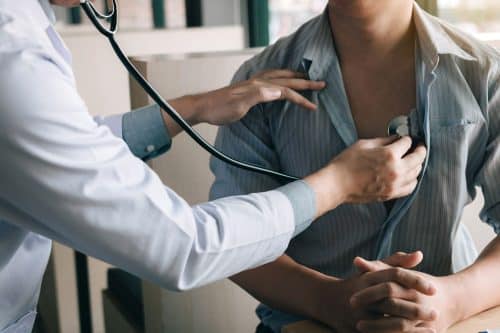 Doctor examining sick patient