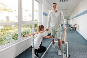 A young man recovering in physical therapy after a car accident in Mobile, AL.