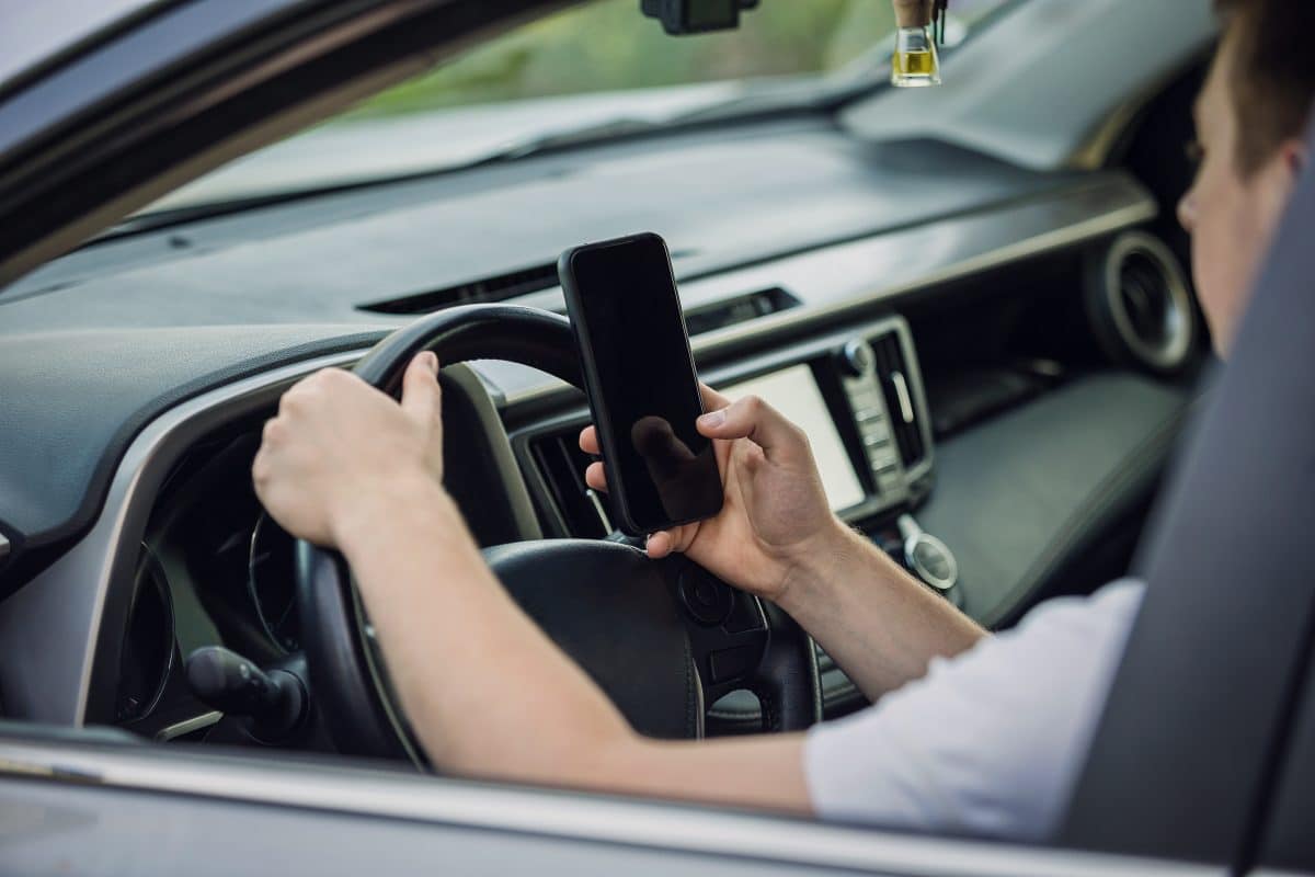 Uber driver texting on his phone while driving in Orange Beach, Alabama